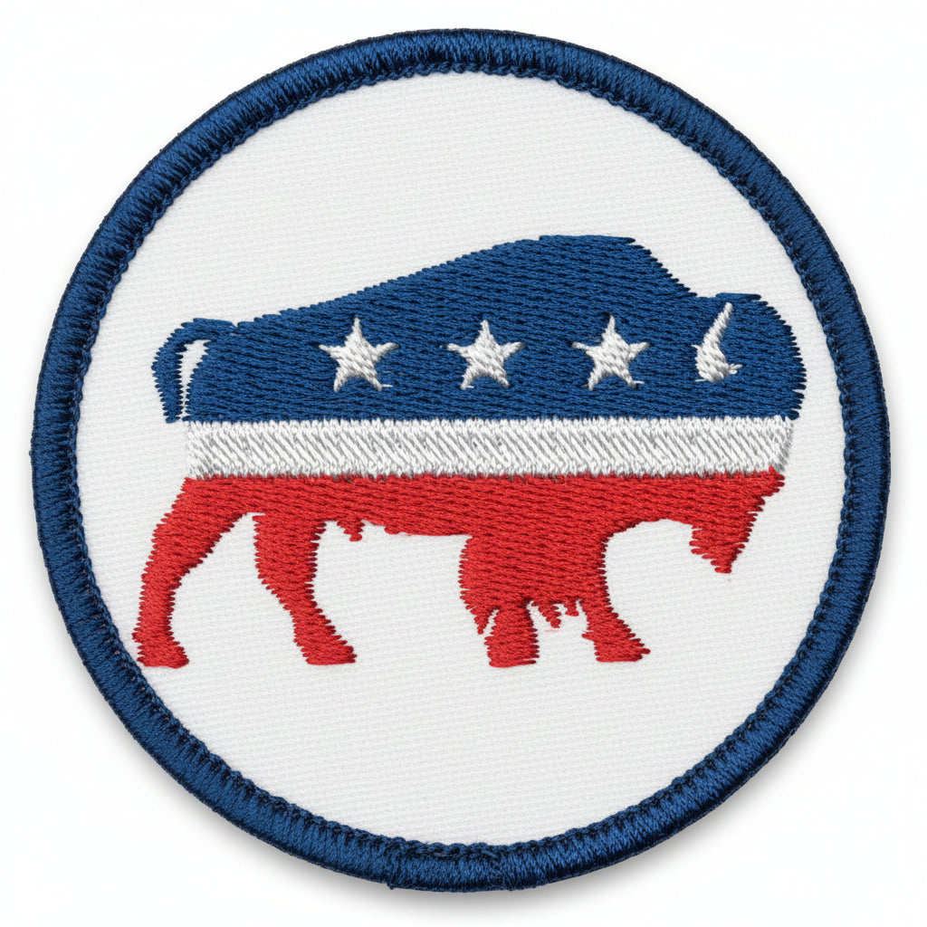 An embroidered patch featuring a bison with stars on its body, red and blue color scheme, circular border.
