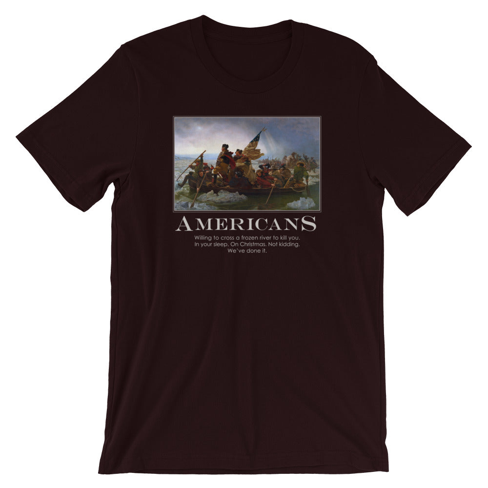 an Oxford black t-shirt from Liberty Maniacs. The t-shirt features a large graphic of the historical painting "Washington Crossing the Delaware." Below the painting, the word "AMERICANS" is written in a large, bold font. Underneath, smaller text reads: "Willing to cross a frozen river to kill you in your sleep. On Christmas. Not kidding. We've done it."