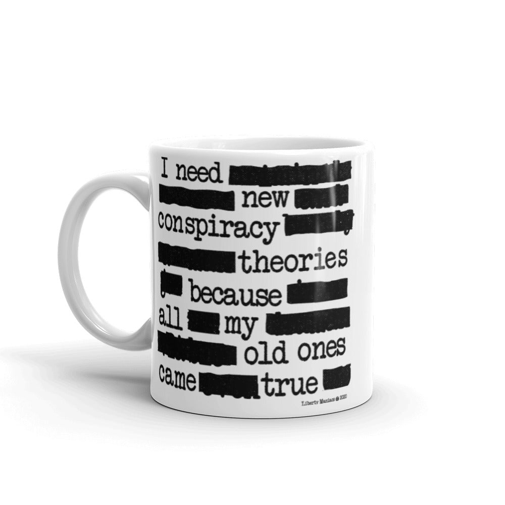 White 11 oz ceramic mug by Liberty Maniacs with text pattern depicting a humorous conspiracy theory statement "I need new conspiracy theories because all my old ones came true."