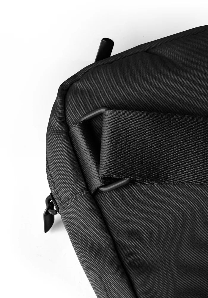 Close-up of a black bag with a strap on a white background