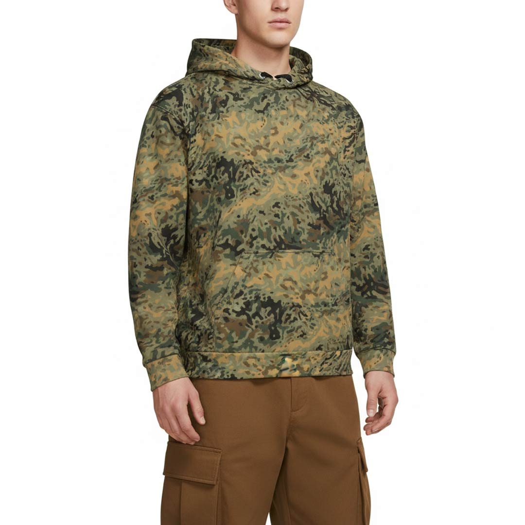 Person wearing a camouflage hoodie and brown pants on a white background