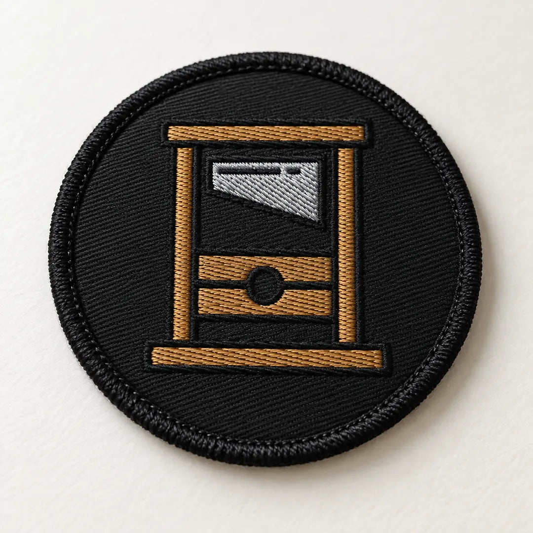 A round Guillotine Embroidered circle patch.