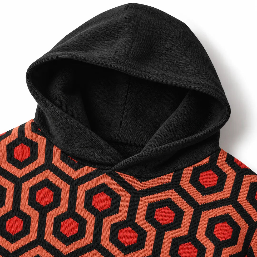 Close-up of Overlook Knit Hoodie showing black hood and geometric jacquard-knit pattern