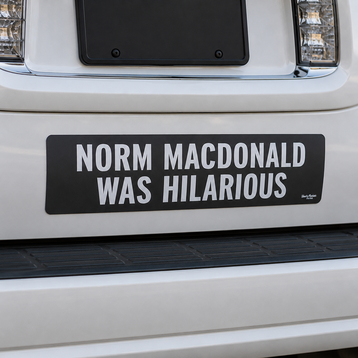 Norm MacDonald was hilarious bumper sticker on a white SUV. 