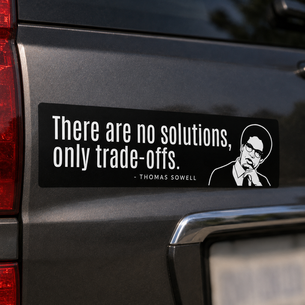 Thomas Sowell Tradeoffs Bumper Sticker on the tailgate of an SUV