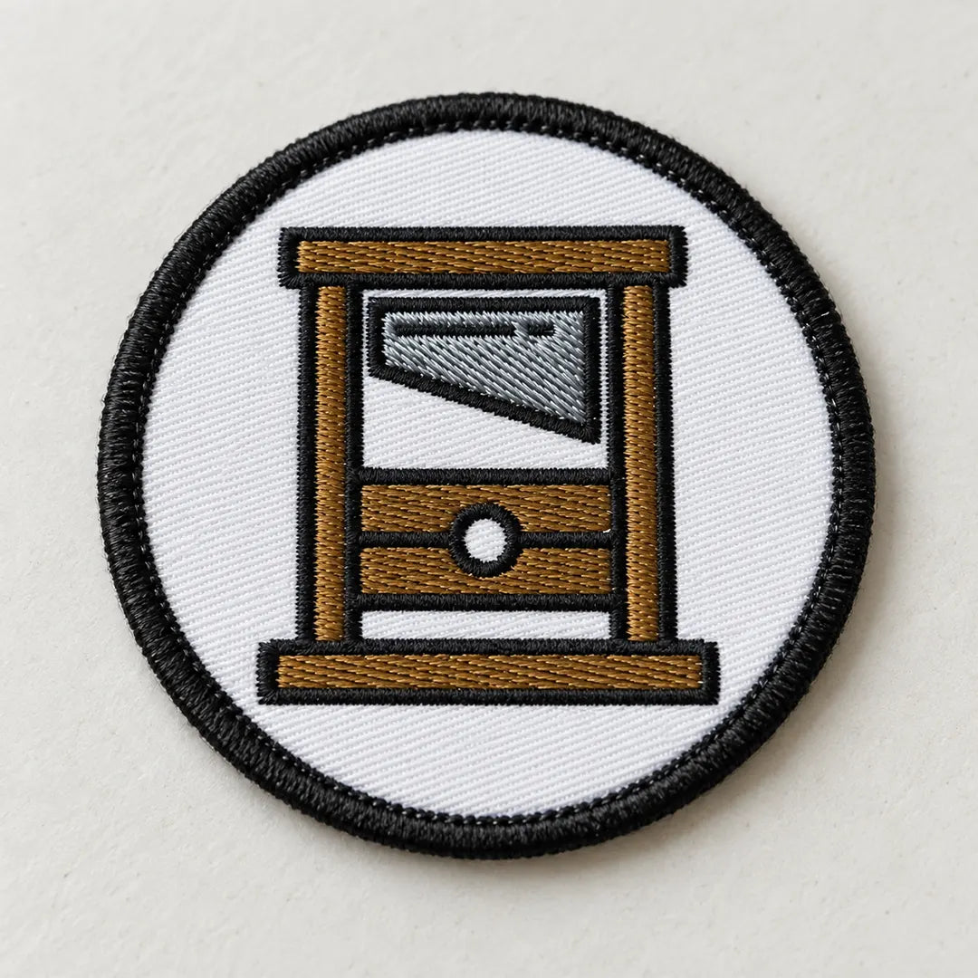 A round Guillotine Embroidered circle patch.
