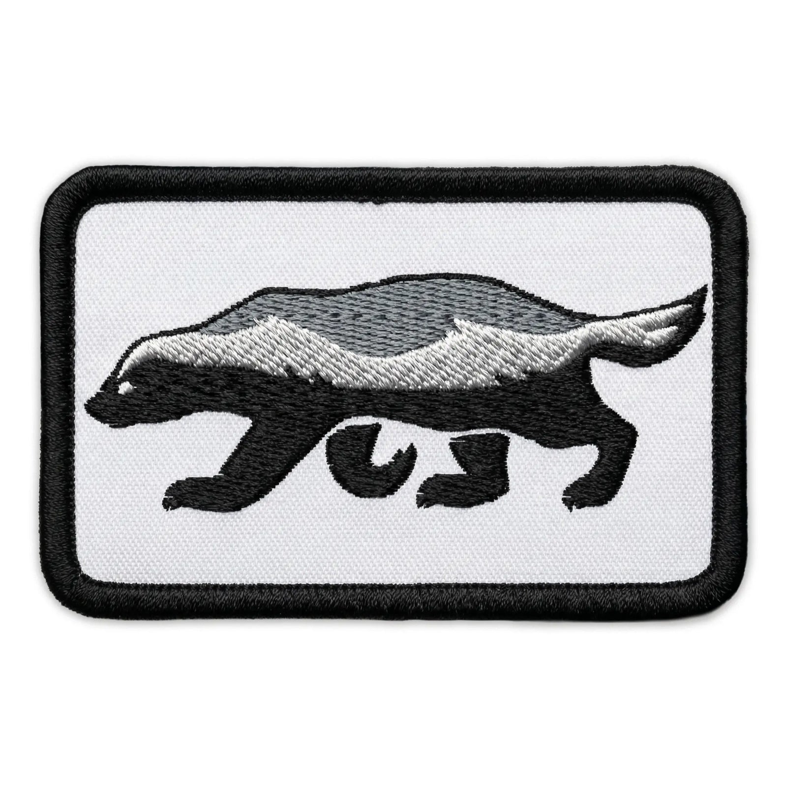 Embroidered patch of a honey badger on a white background