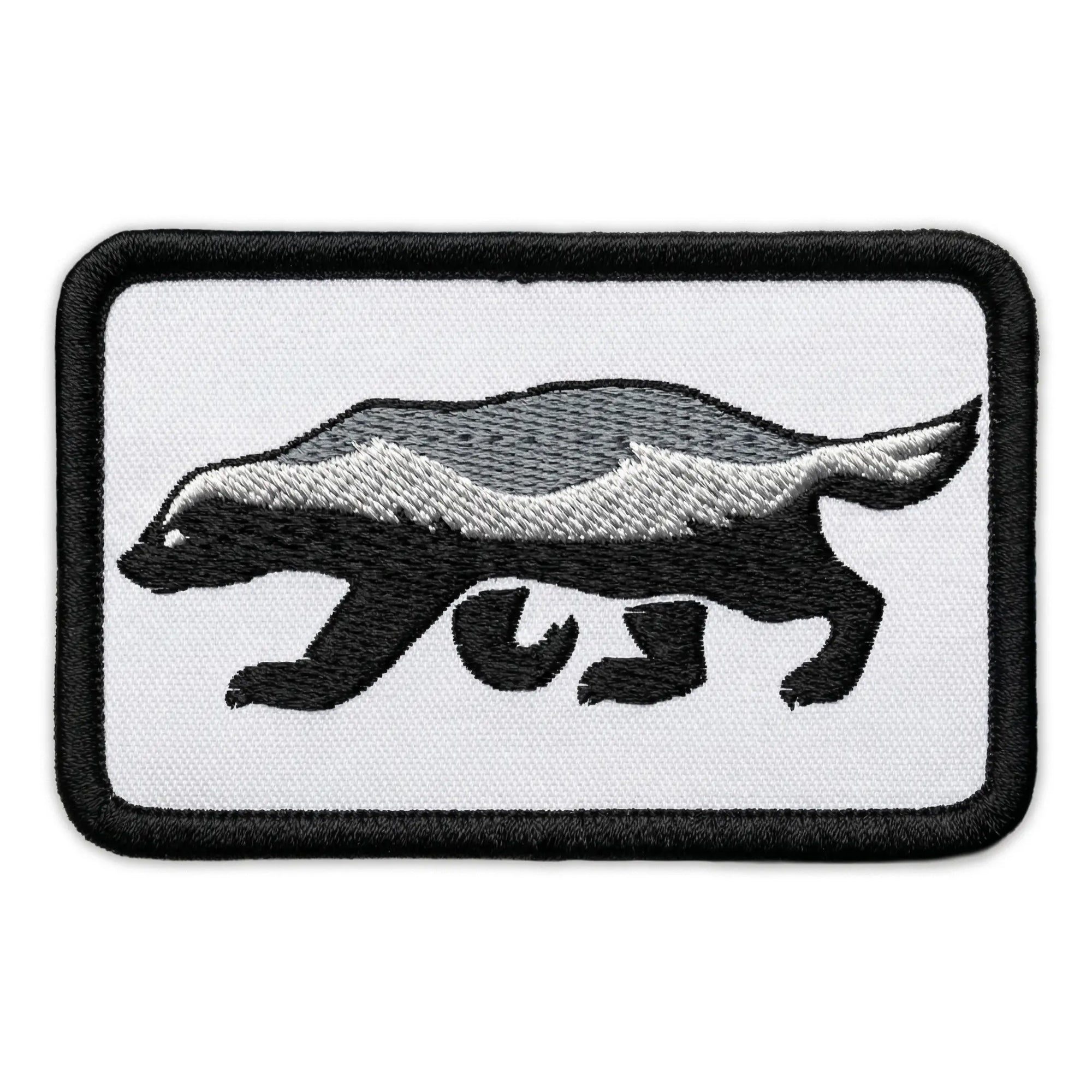 Embroidered patch of a honey badger on a white background