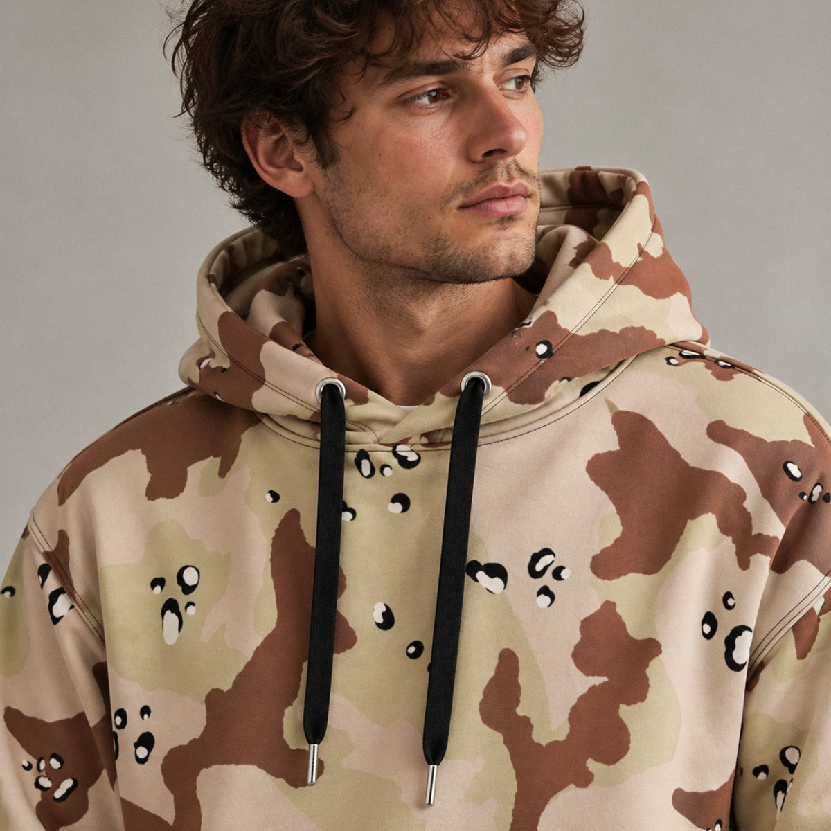 1972 experimental desert camo hoodie on male model showing hood, dropped shoulders and relaxed fit