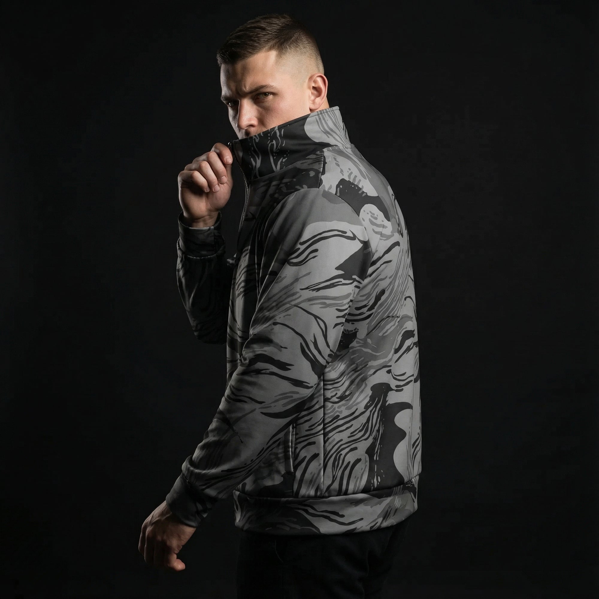 Man wearing a camouflage jacket on a black background