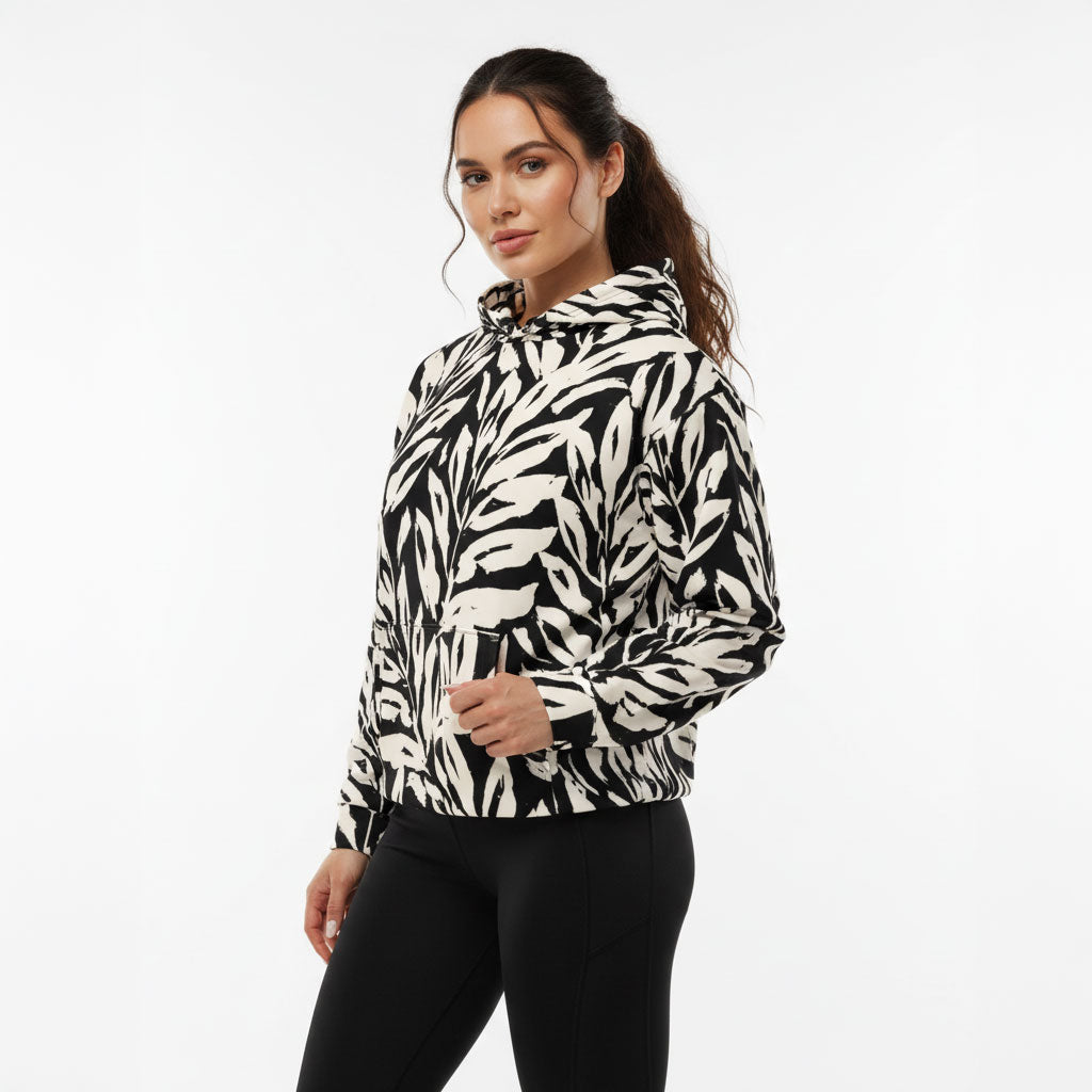 Woman wearing a black and white patterned hoodie on a white background