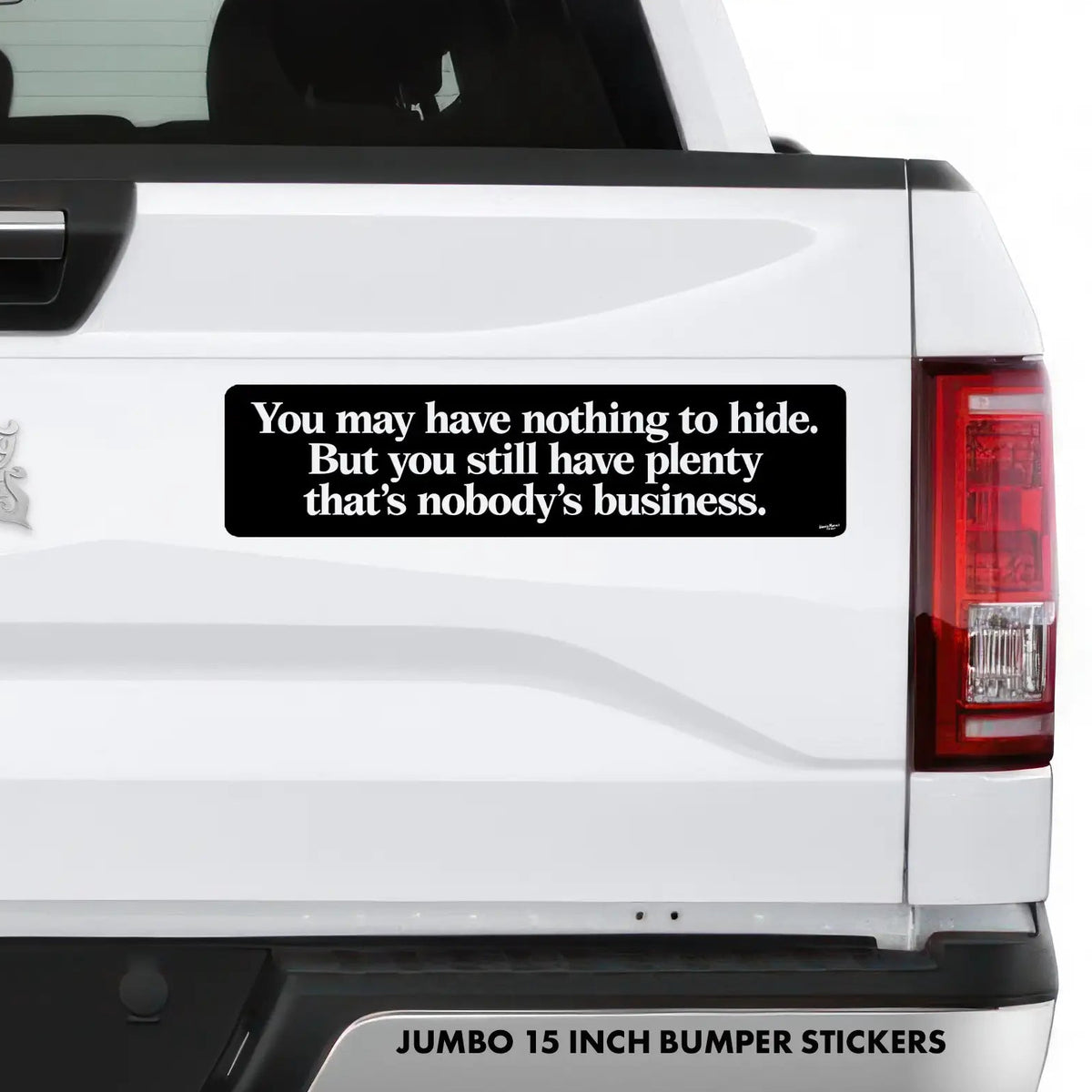 A black rectangular bumper sticker with white text reading 'You may have nothing to hide. But you still have plenty that nobody's business.