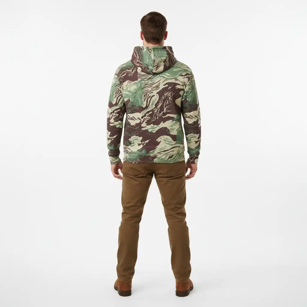 Person wearing a Rhodesian Brushstroke Camo Cotton Hoodie by Liberty Maniacs and brown pants on a white background