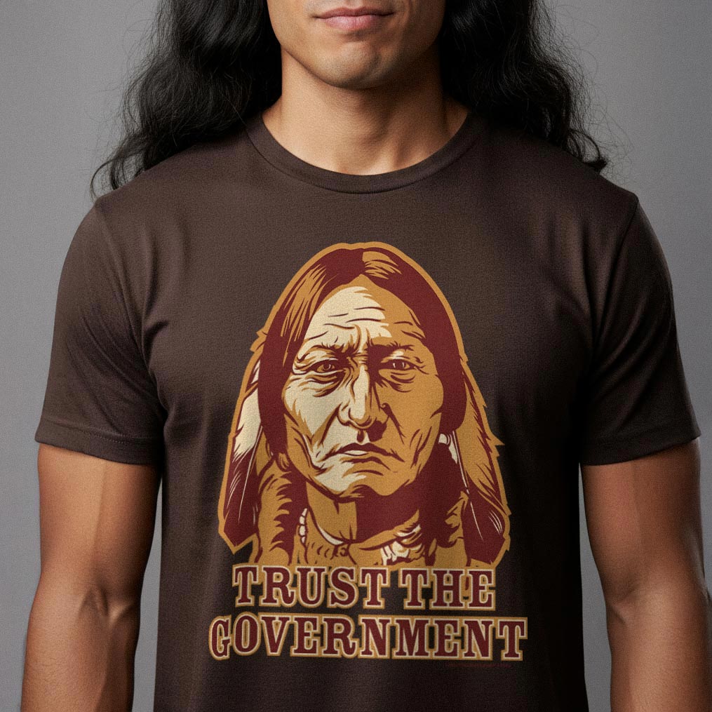 Person wearing a brown t-shirt with a graphic of a Native American chief Sitting Bull and text &#39;TRUST THE GOVERNMENT&#39; from Liberty Maniacs.