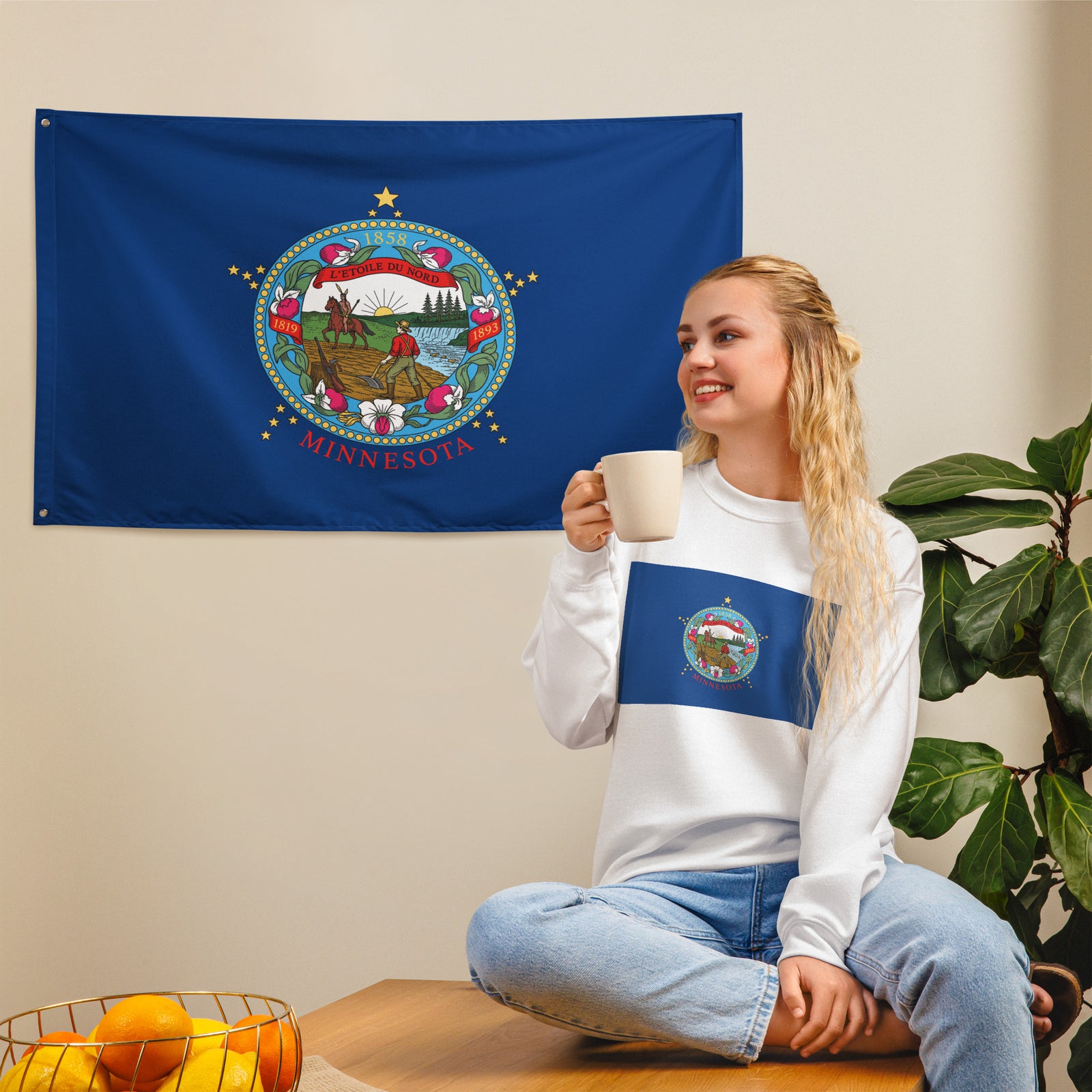 Woman holding a mug in front of a Minnesota state flag