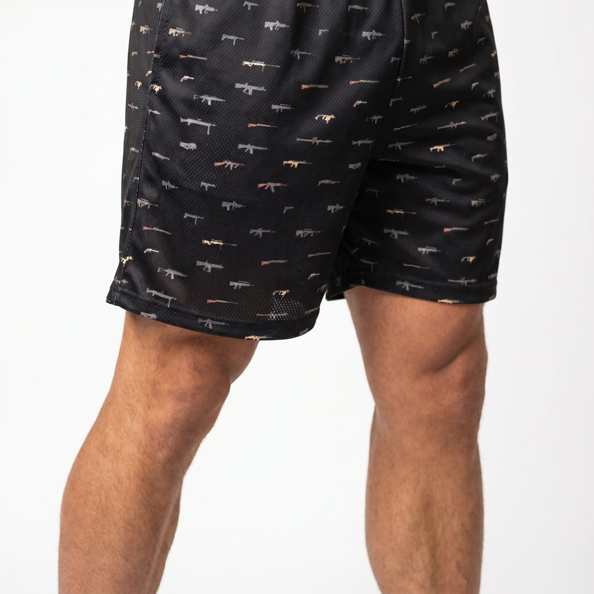 Black shorts with small patterns worn by a person on a white background
