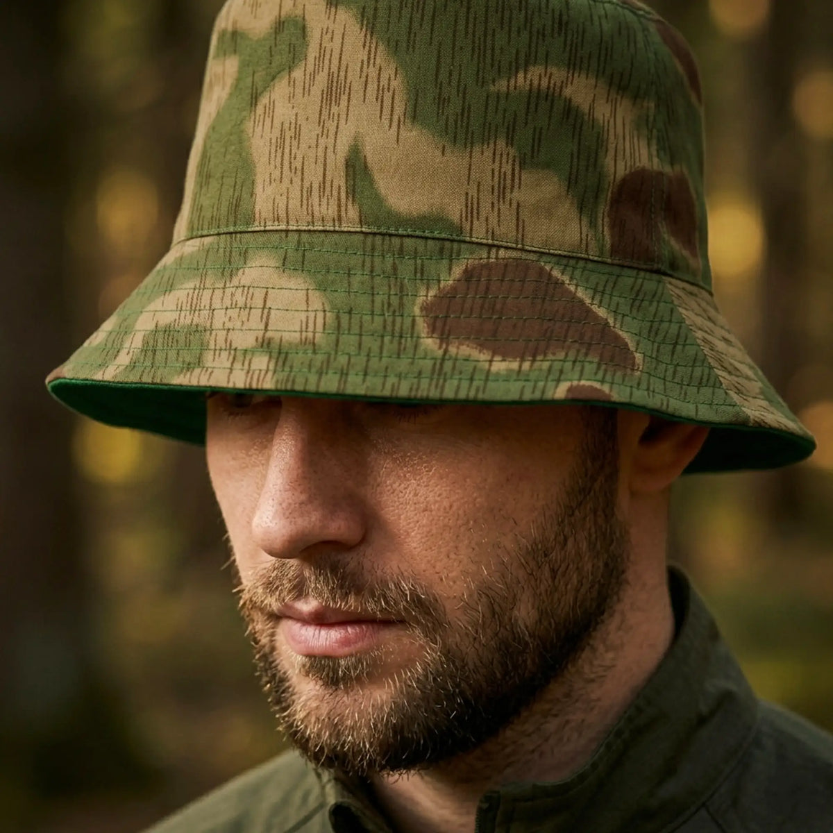 Man wearing a camouflage bucket hat with a blurred natural background