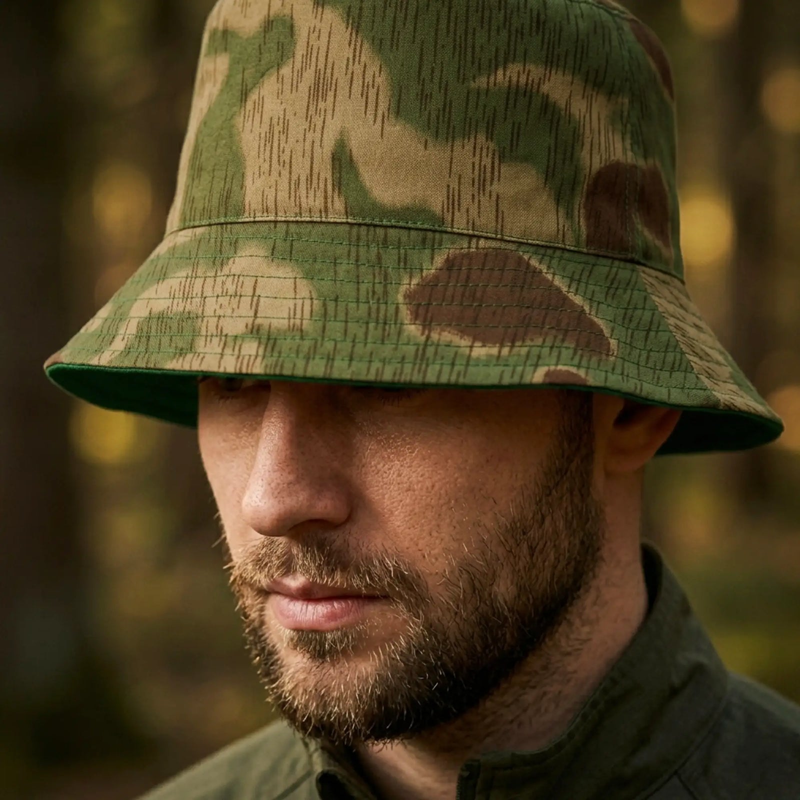 Man wearing a camouflage bucket hat with a blurred natural background