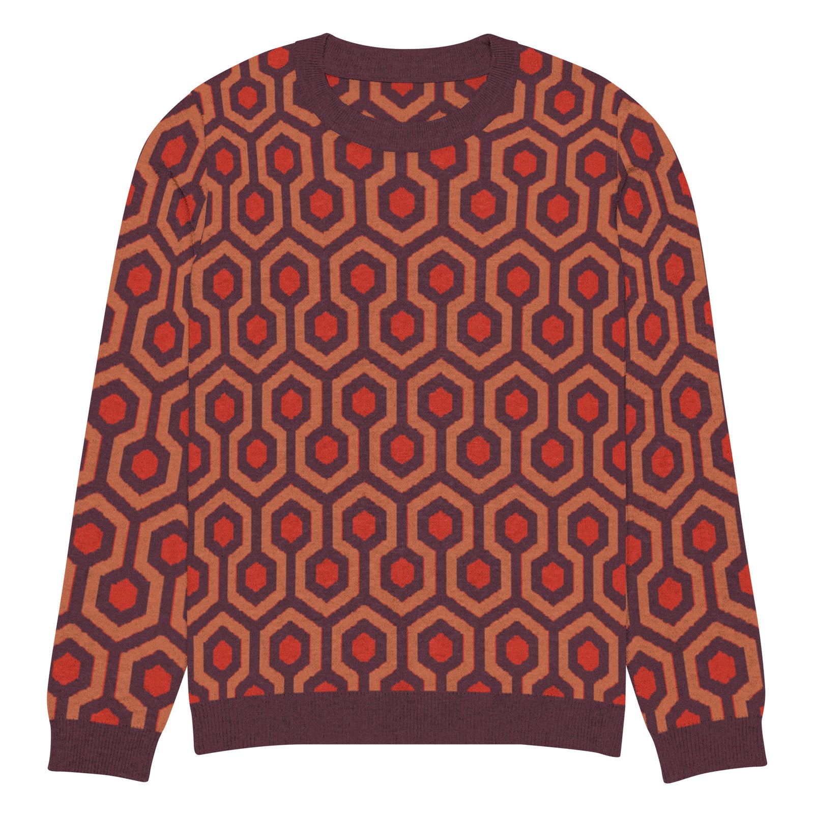 Person wearing a patterned sweater with red and brown hexagonal design on a gray background