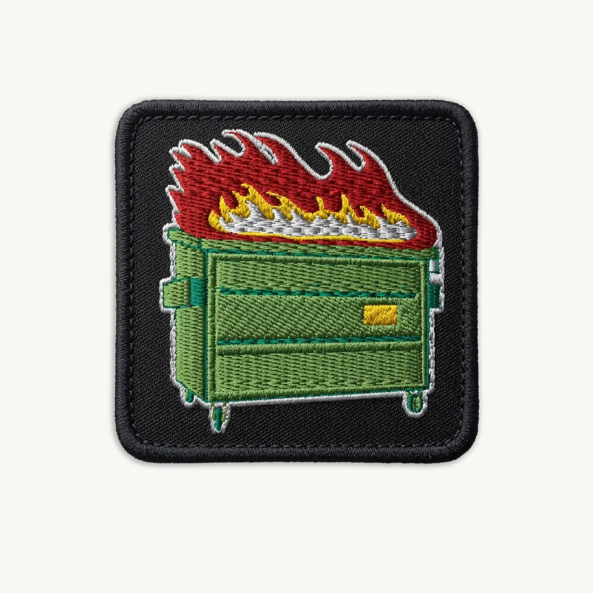 Embroidered patch of a green dumpster on fire with flames on a black border.