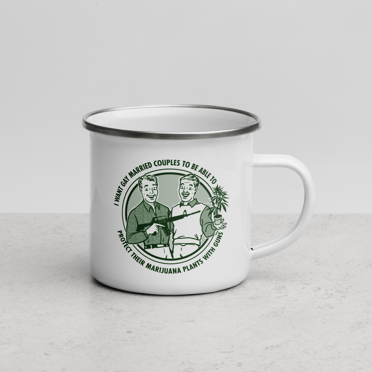 A white enamel-style mug with a silver-toned rim and handle, featuring a green vintage-style illustration and text on the front, photographed on a light gray surface against a pale gray background.