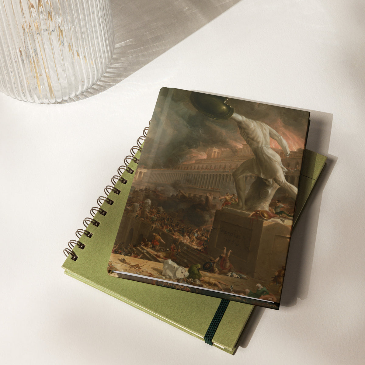 Notebook with classical painting cover on a white surface