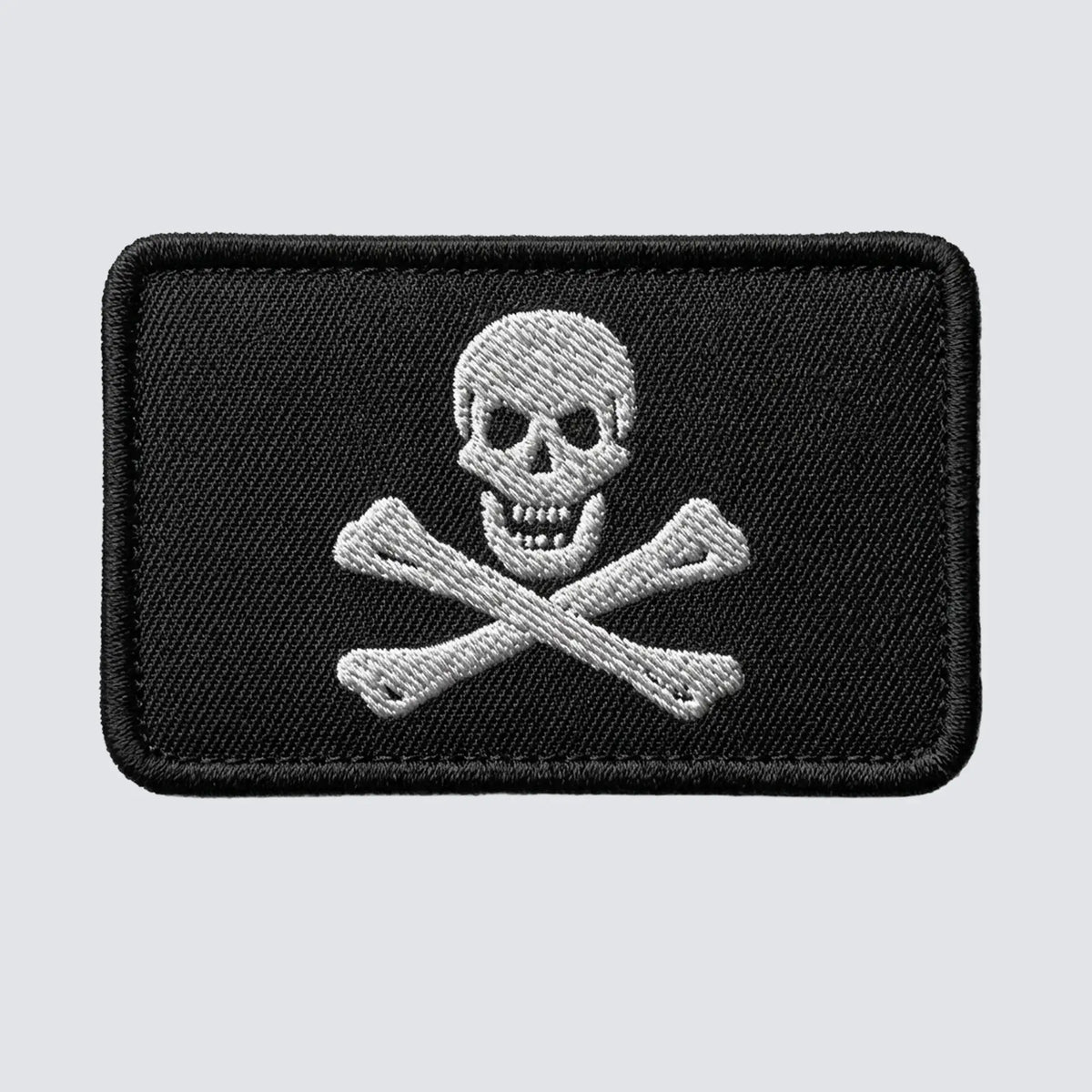 Embroidered patch with skull and crossbones design on a black background