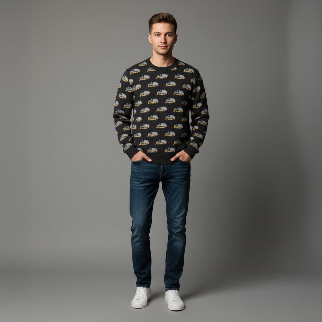 Man wearing a patterned sweater and jeans on a gray background