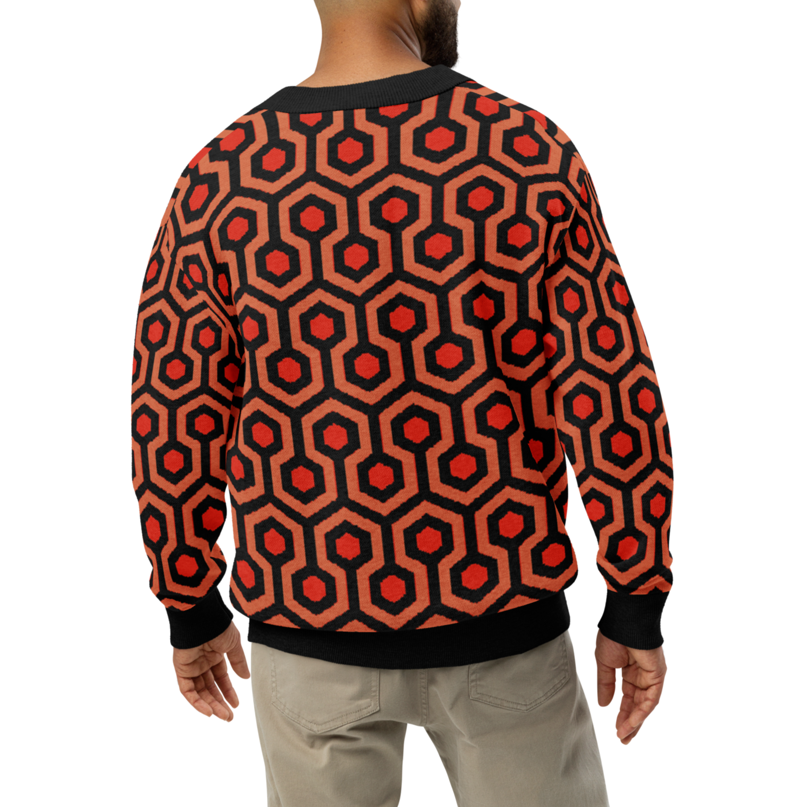 Person wearing a red and black patterned sweater on a white background