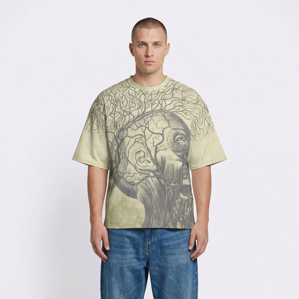 Man wearing a light green t-shirt with a graphic design on a plain background