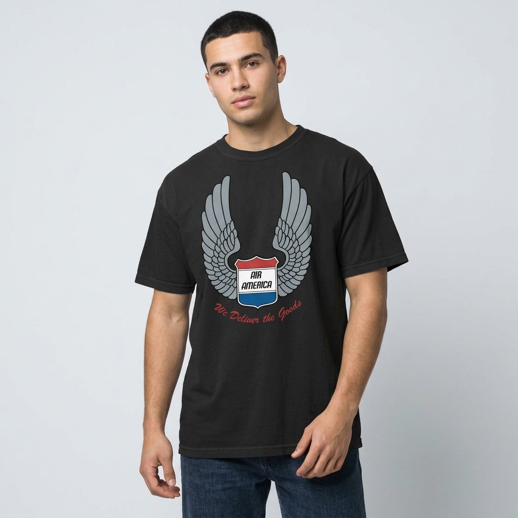 Man wearing a black t-shirt with a logo on a plain background