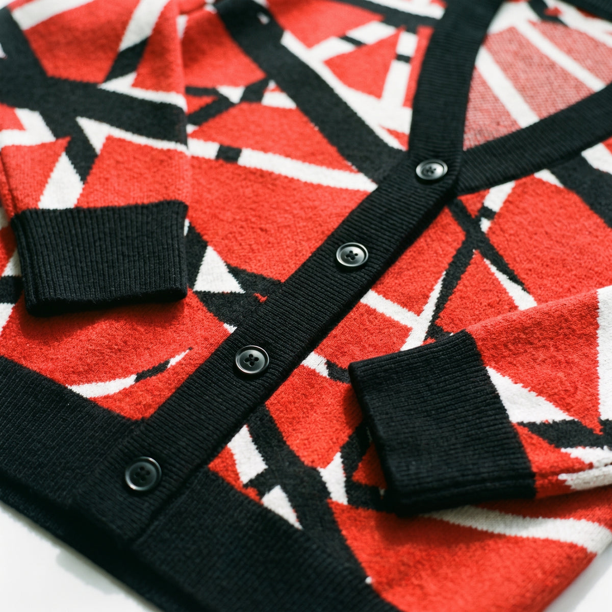 Frankenstripes red, black and white jacquard-knit cardigan, close-up of knit pattern and ribbed trim