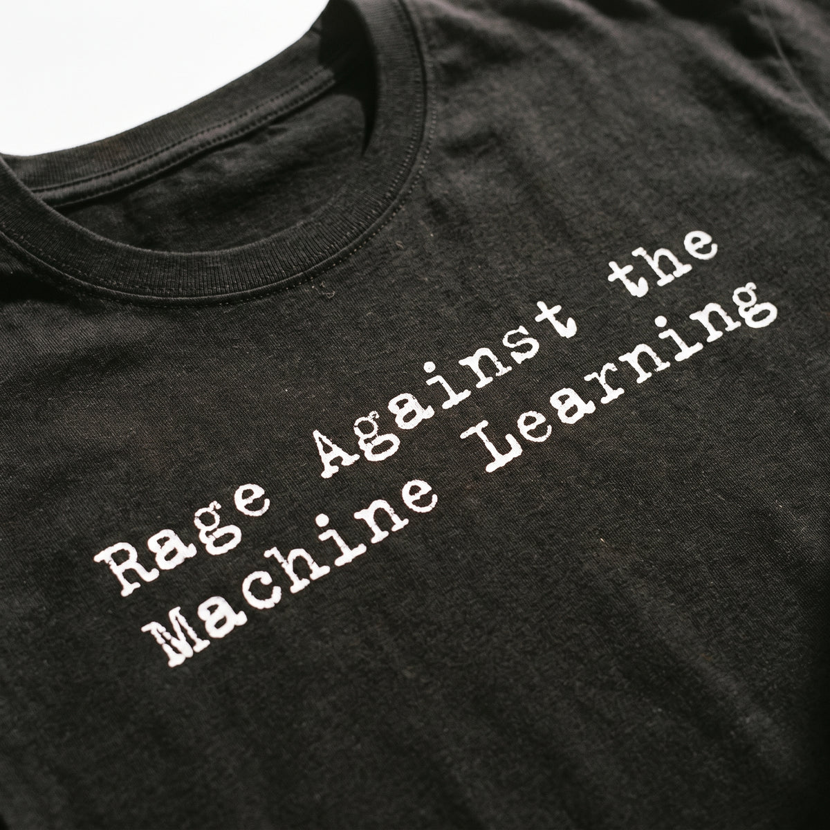 Close-up of the white typewriter-style Rage Against the Machine Learning print