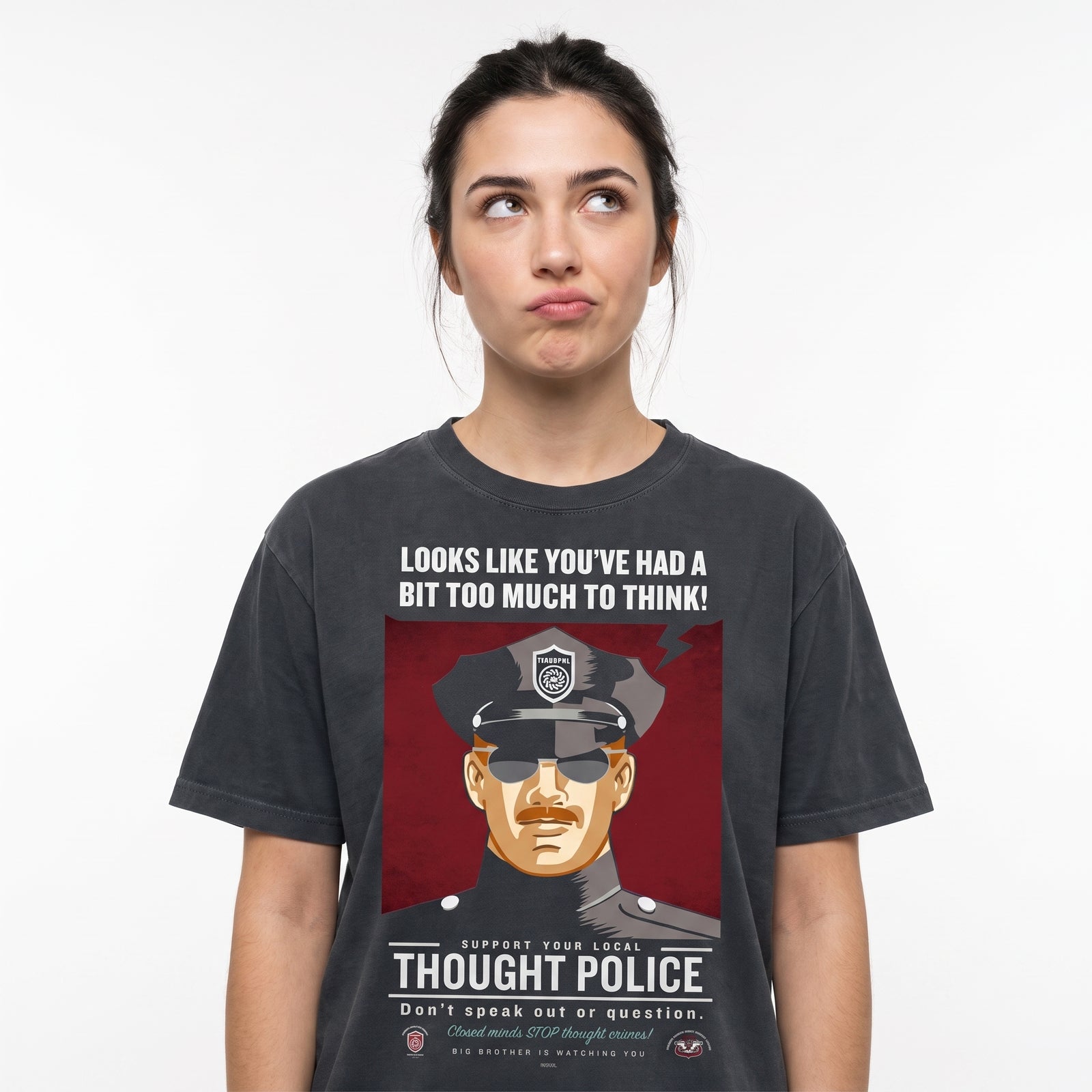 A dark charcoal gray graphic t-shirt featuring a satirical political cartoon of a police officer with the text 'LOOKS LIKE YOU'VE HAD A BIT TOO MUCH TO THINK!' and 'SUPPORT YOUR LOCAL THOUGHT POLICE'.