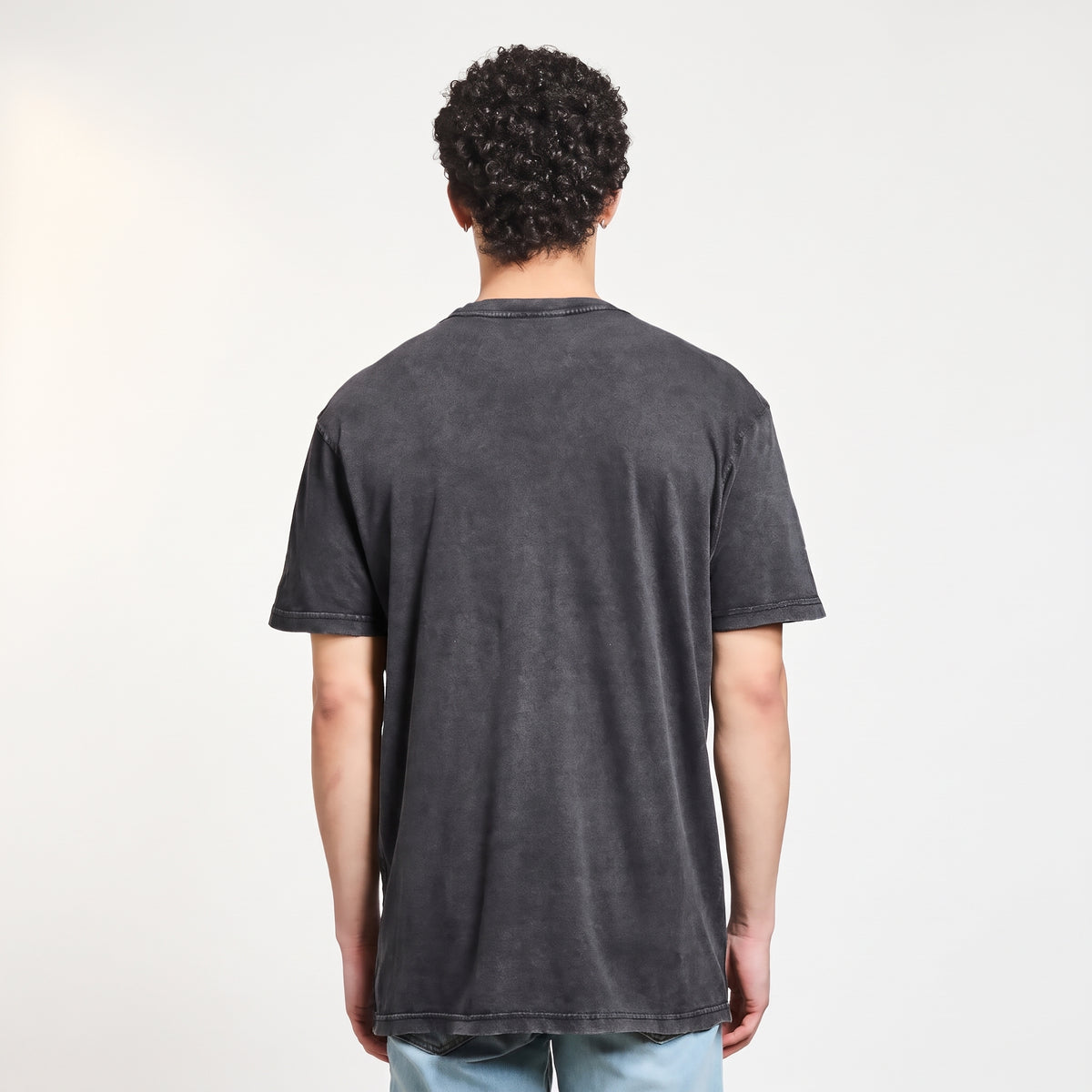 Male model wearing The Pentagon Vintage Concert Tee, back studio view showing mineral-washed cotton fit
