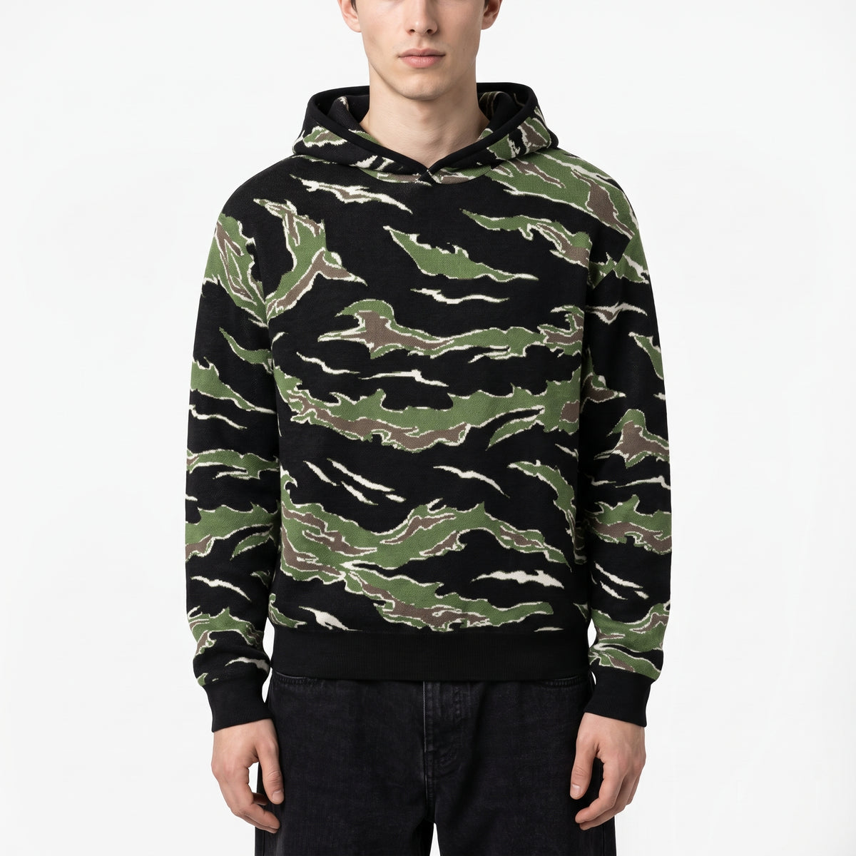 Male model wearing the Tiger Stripe Camo Sweater Hoodie, front studio photograph