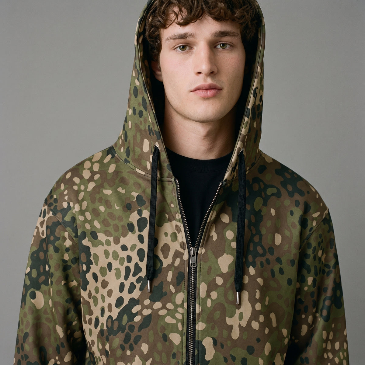 Close-up of man wearing the Field Green Erbsenmuster Pea Dot zip hoodie