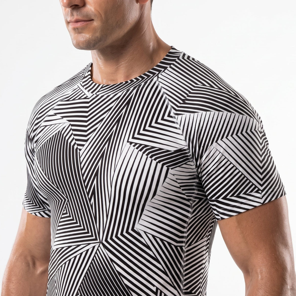 A man wearing a short-sleeve athletic compression shirt with a black and white geometric stripe pattern, shown from the waist up against a plain white background.