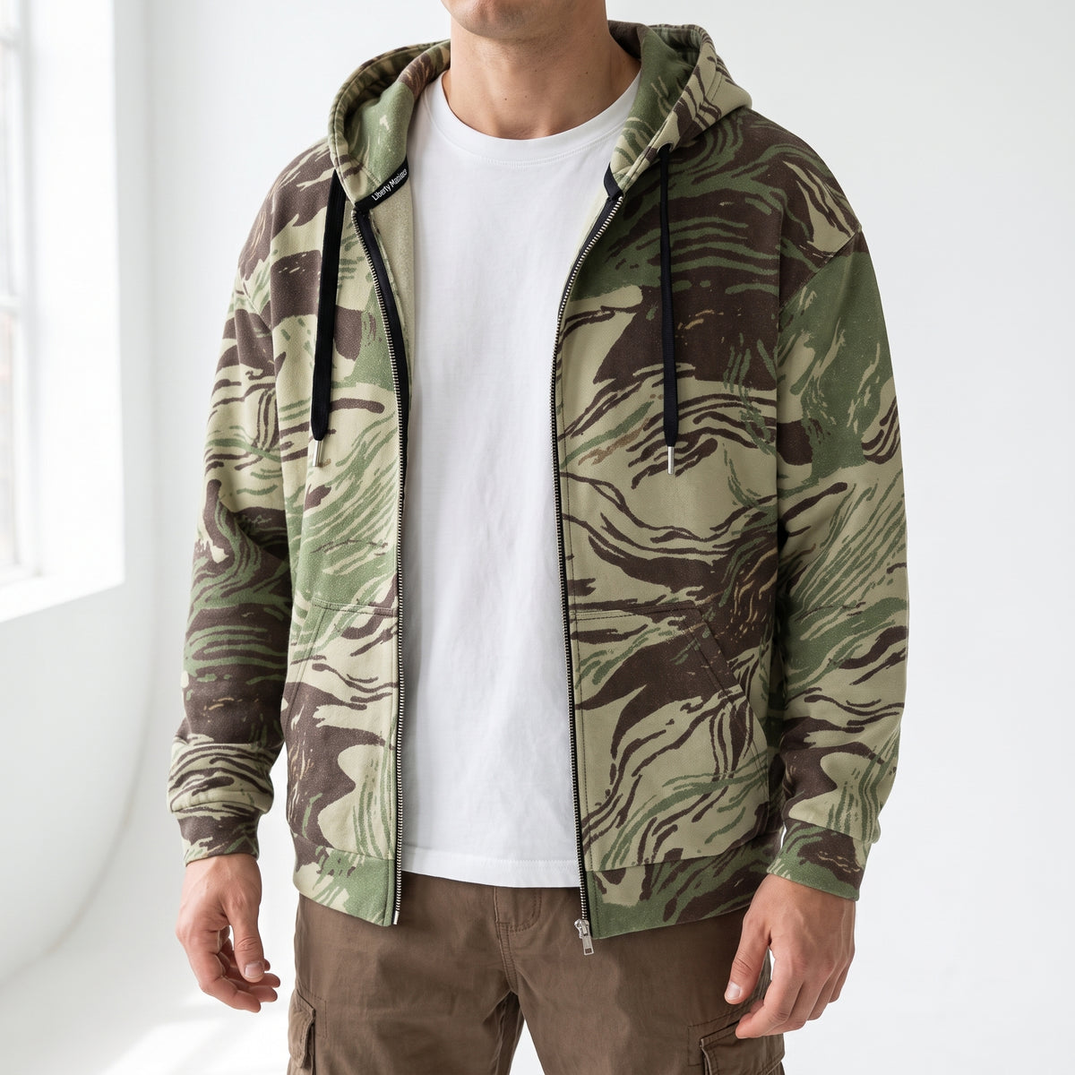 Close-up of man wearing the Rhodesian Brushstroke camouflage zip hoodie