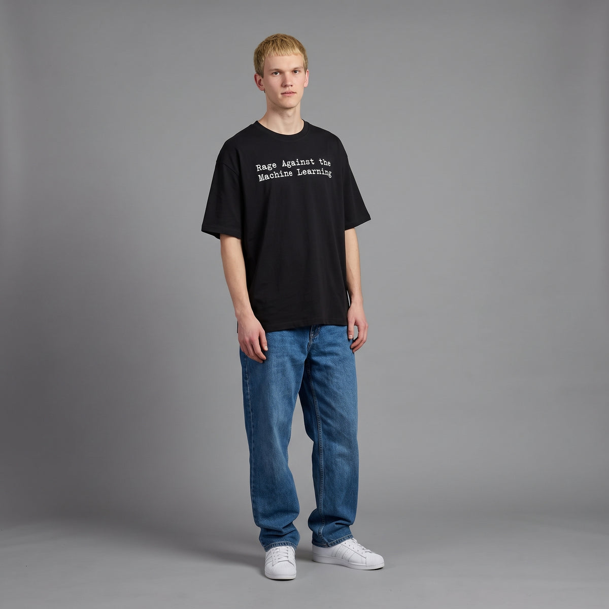 Full-length view of a man wearing the oversized black Machine Learning tee