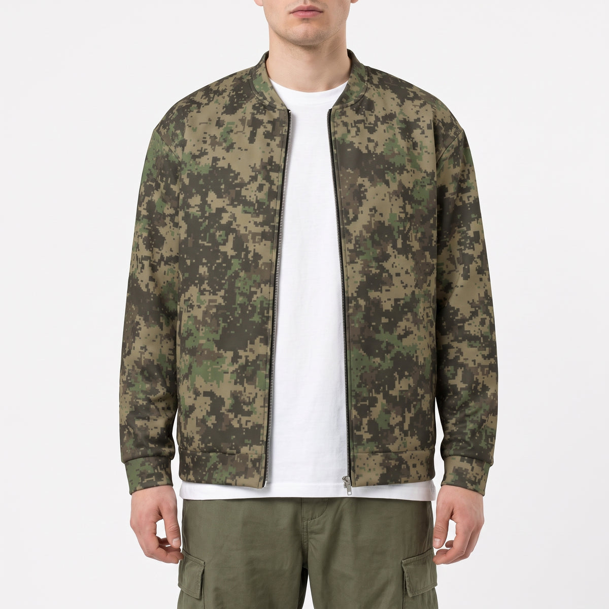 A man wearing a digital camouflage bomber jacket over a white t-shirt and olive cargo pants, photographed against a clean white studio background.