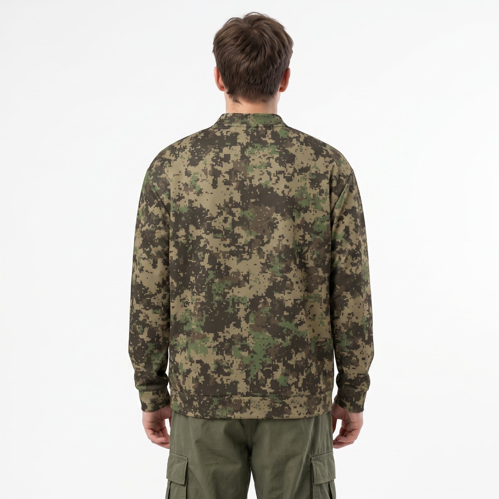 A man wearing a digital camouflage bomber jacket over a white t-shirt and olive cargo pants, photographed against a clean white studio background.