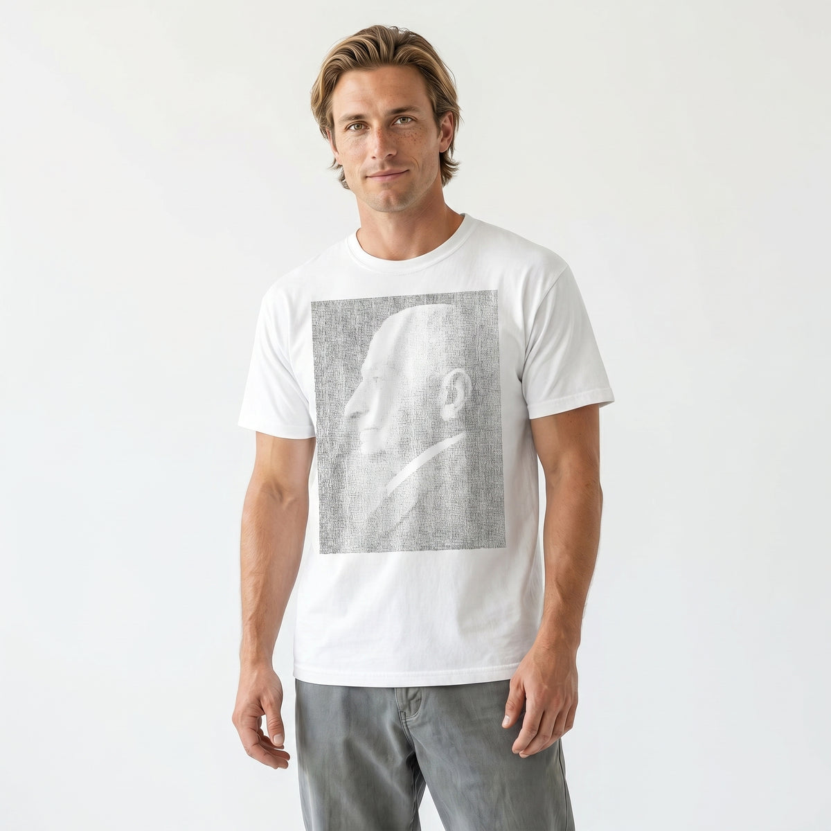 Man wearing a white t-shirt with a graphic design on a plain background