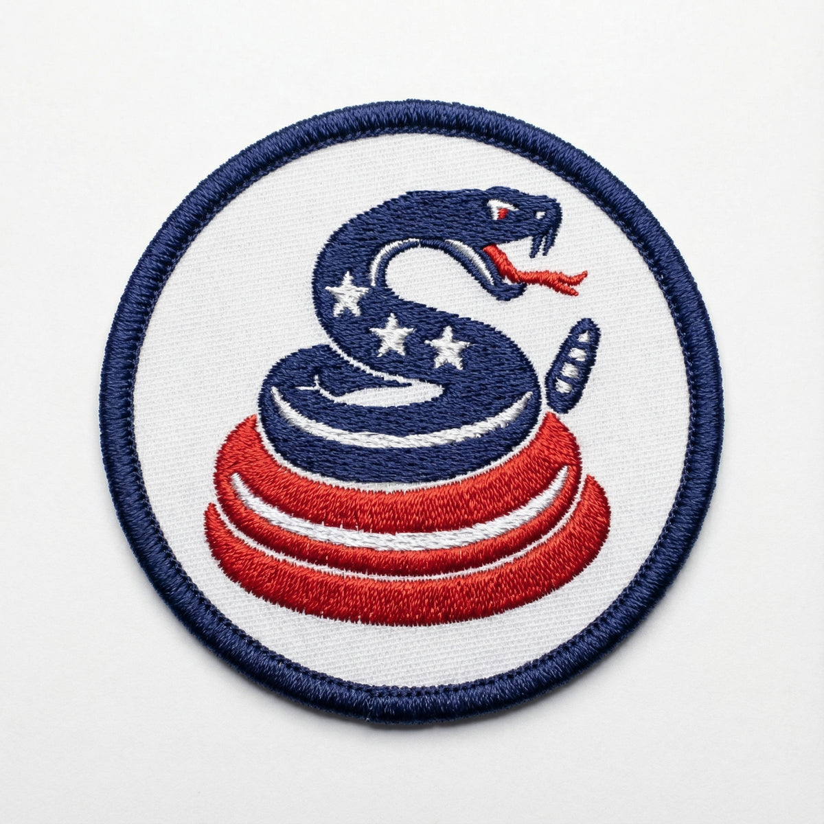 Embroidered patch with a snake design on a white background