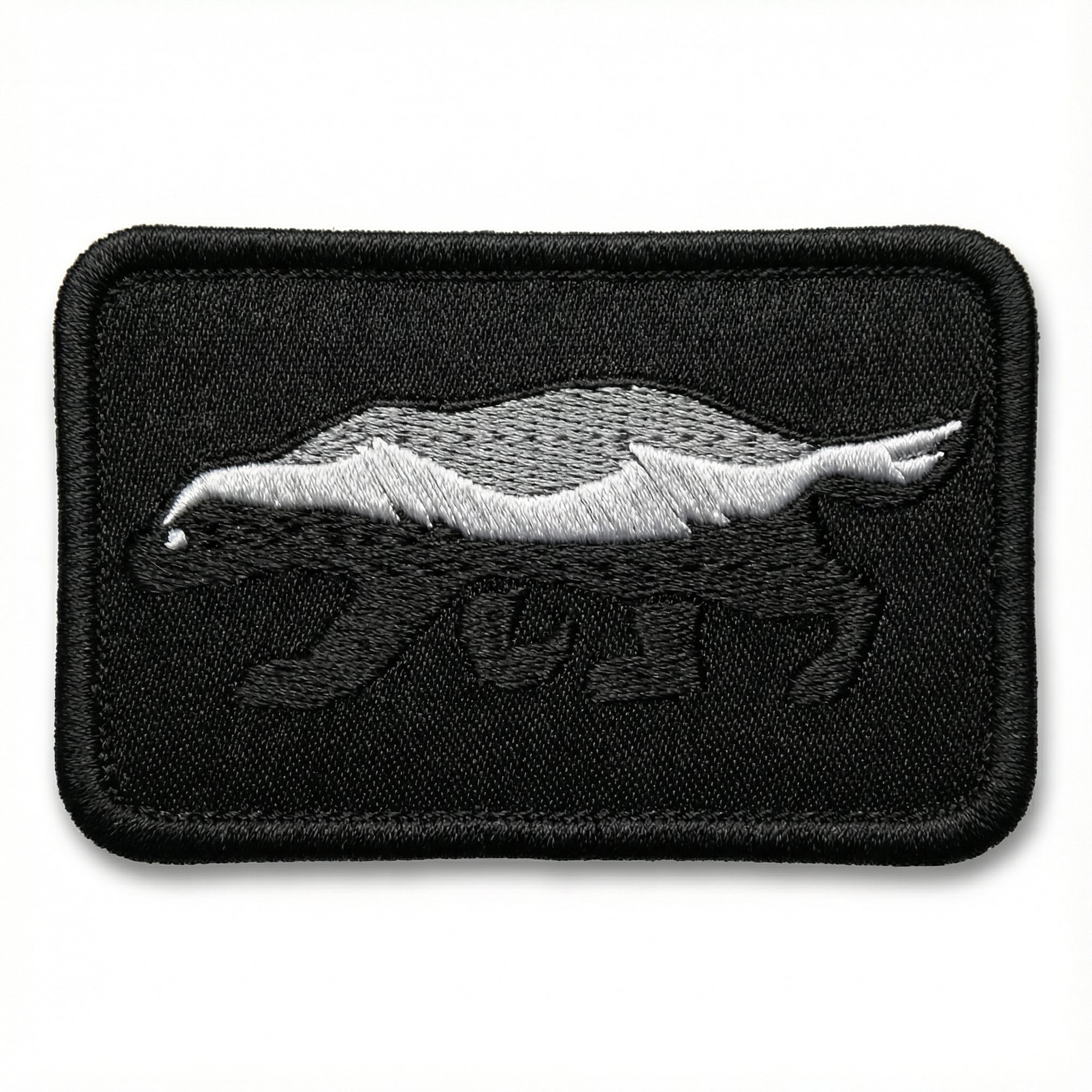 Embroidered patch of a honey badger on a white background