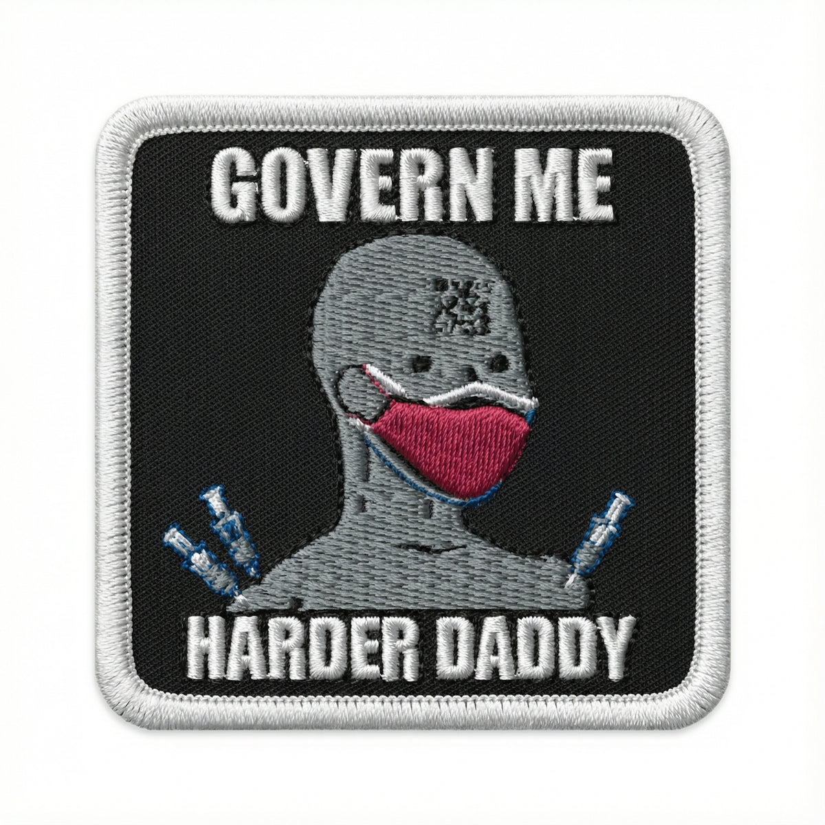 Embroidered patch with a NPC wearing a mask and text &#39; Govern Me Harder Daddy&#39; on a black background.