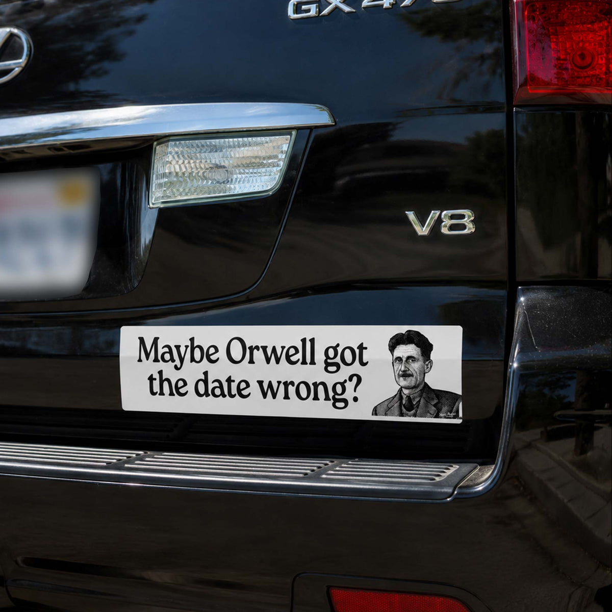 Black Lexus GX470 with a sticker questioning George Orwell's date of birth on the rear window.