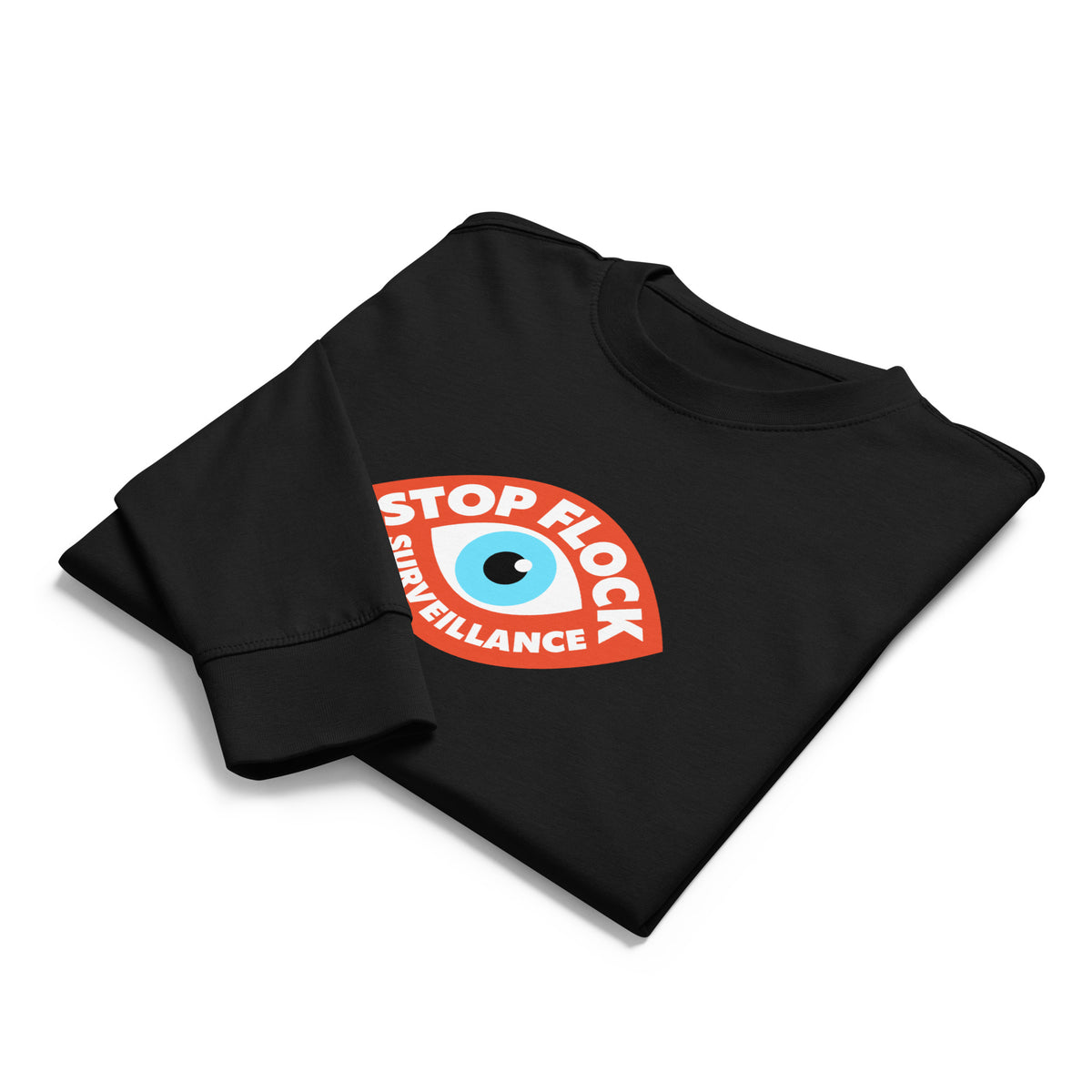 A black long-sleeve t-shirt folded neatly on a white background, featuring a circular graphic on the chest with an eye illustration and the text 'STOP FLOCK SURVEILLANCE'.
