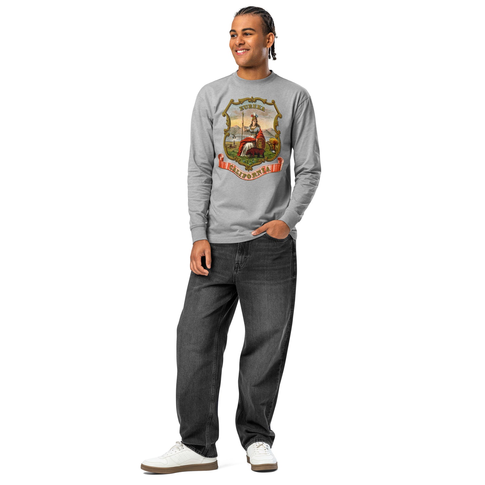 Full-length view of a man wearing the Carbon Grey California State Seal heavyweight long sleeve T-shirt with dark jeans.