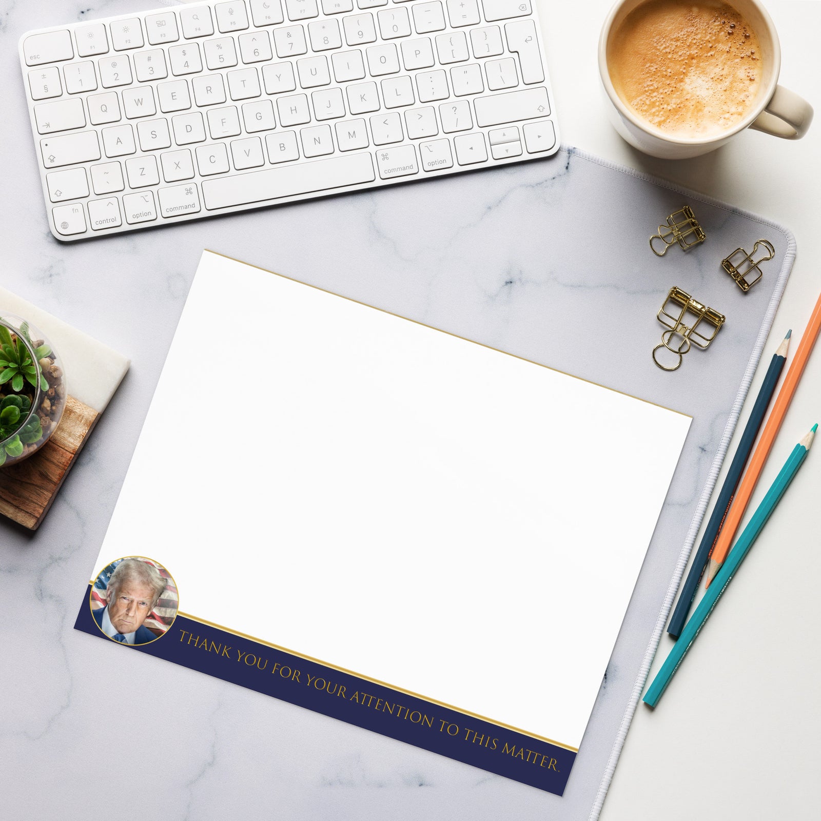 Desk setup with a letterhead featuring a photo and text, keyboard, coffee cup, and office supplies.